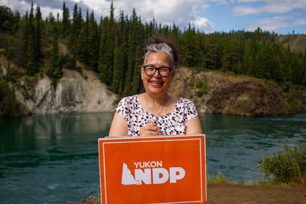 Linda Moen poses above the Yukon River at Miles Canyon